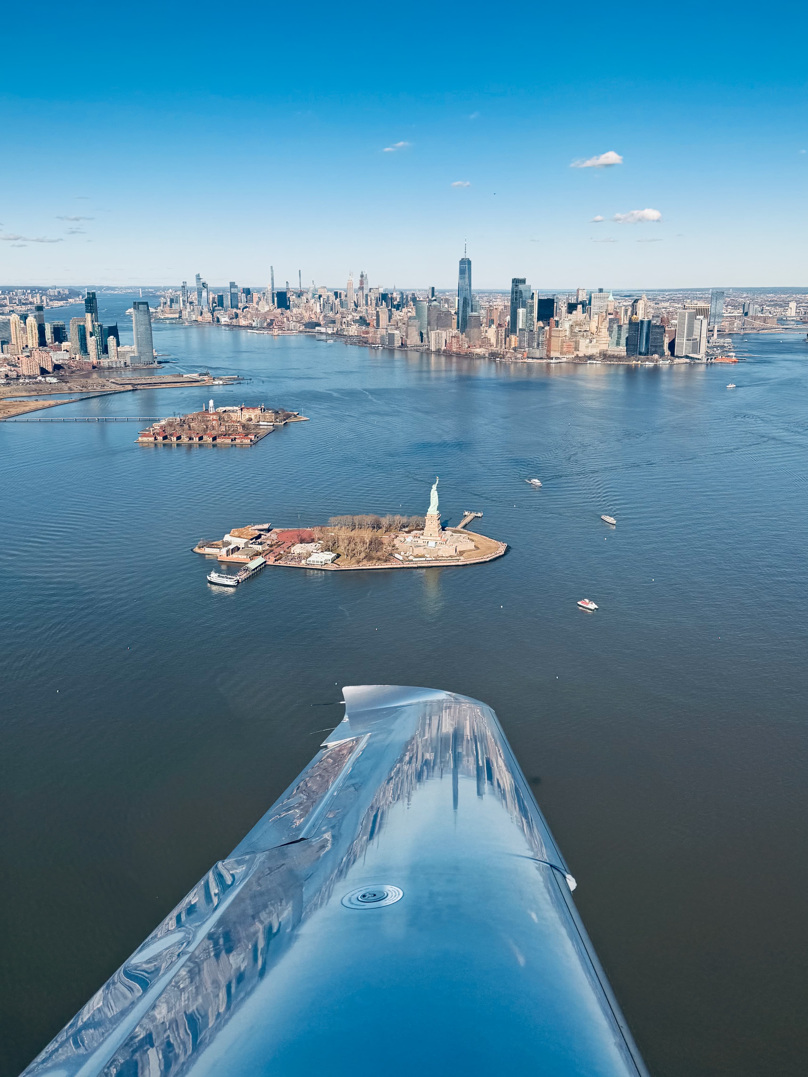 The Statue of Liberty and lower Manhattan off the wingtip